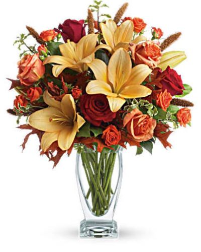<p>Roses, lilies and oak leaves create a fantasy of fall flowers. The warm color palette and Couture Vase make a stylish seasonal statement.</p>