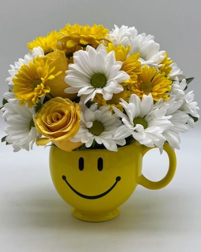 <p>Bursting with cheerful yellow roses and soft white blooms, all arranged in a classic smiley-face mug, this joyful gift is designed to brighten anyone’s day. At the heart of the design are radiant yellow roses, long associated with friendship, optimism, and positivity.</p>