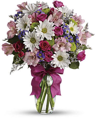 <p>Some bouquets feel like sunshine in a vase—and this one is no exception. The bouquet blends fresh roses and seasonal blooms in a palette of soft pinks, lively purples, and lush greens.</p>