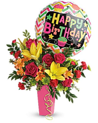 <p>This lively bouquet features hot pink roses, sunny yellow Asiatic lilies, orange alstroemeria, red miniature carnations, green button spray chrysanthemums, huckleberry, and oregonia. These vibrant blooms are presented in a raspberry-hued tapered vase that adds a playful and polished touch.</p>